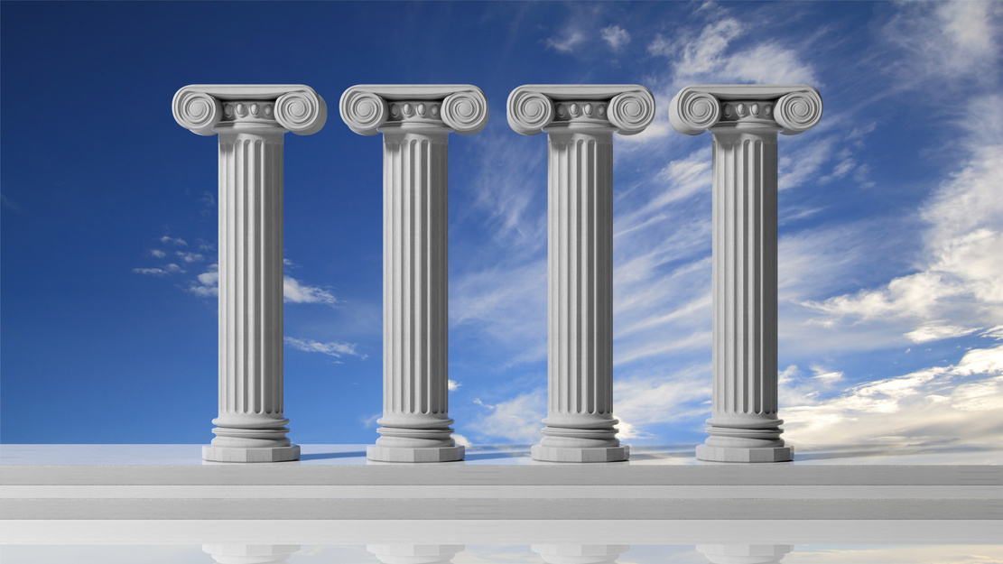 Four ancient pillars with blue sky background.